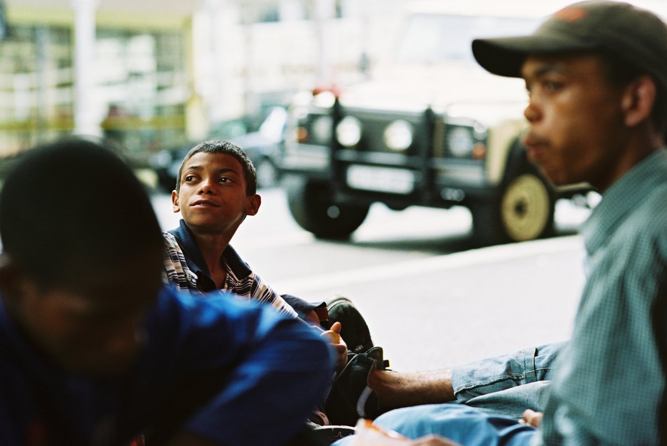 Mogamat. A ‘stroller’ (street kid) on Long Street, sitting outside Mohammad Somali’s corner shop. Cape Town, 2003