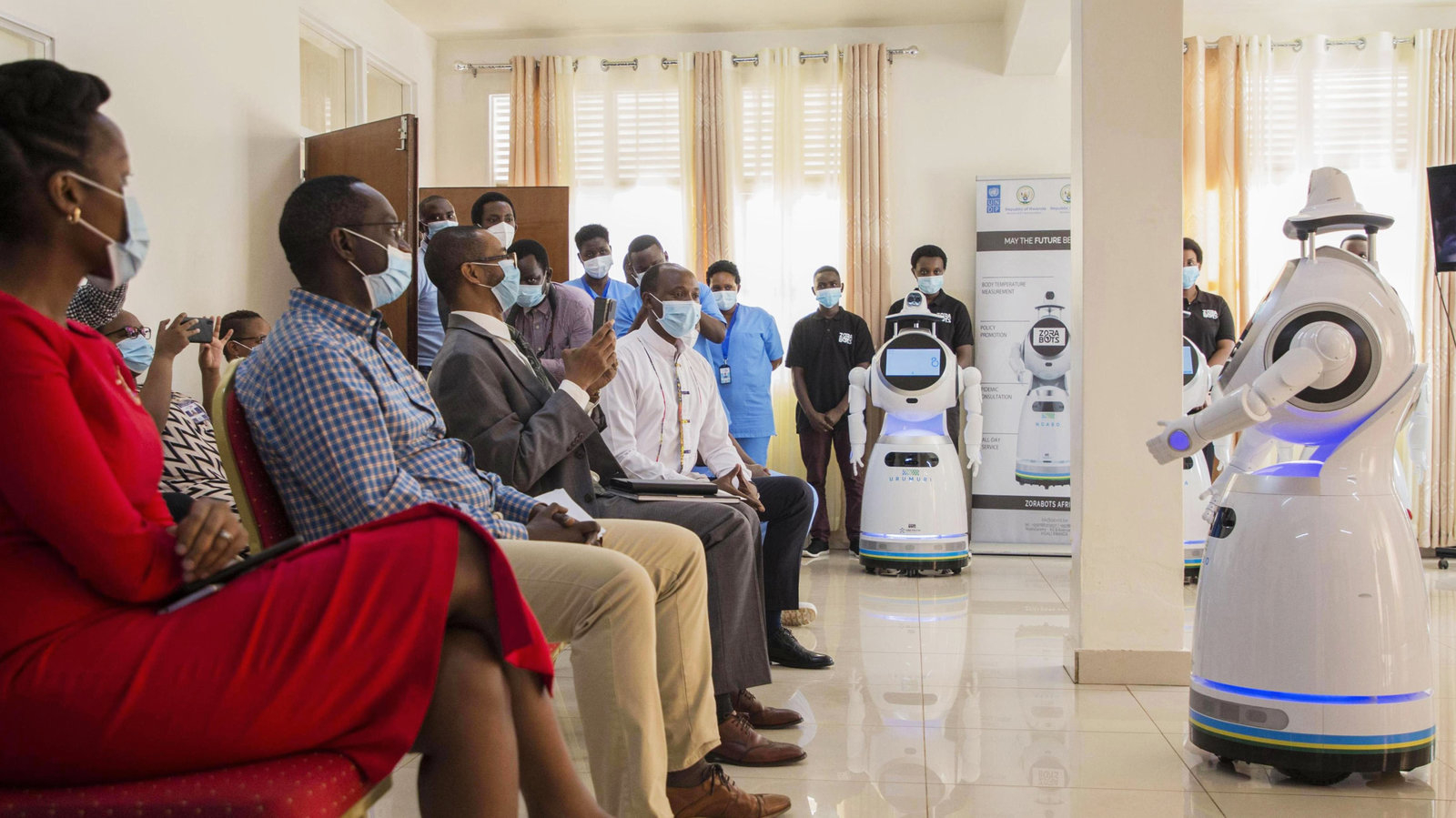 A robot introduces itself to patients in Kigali, Rwanda. The robots, used in Rwanda's treatment centers, can screen people for COVID-19 and deliver food and medication, among other tasks.