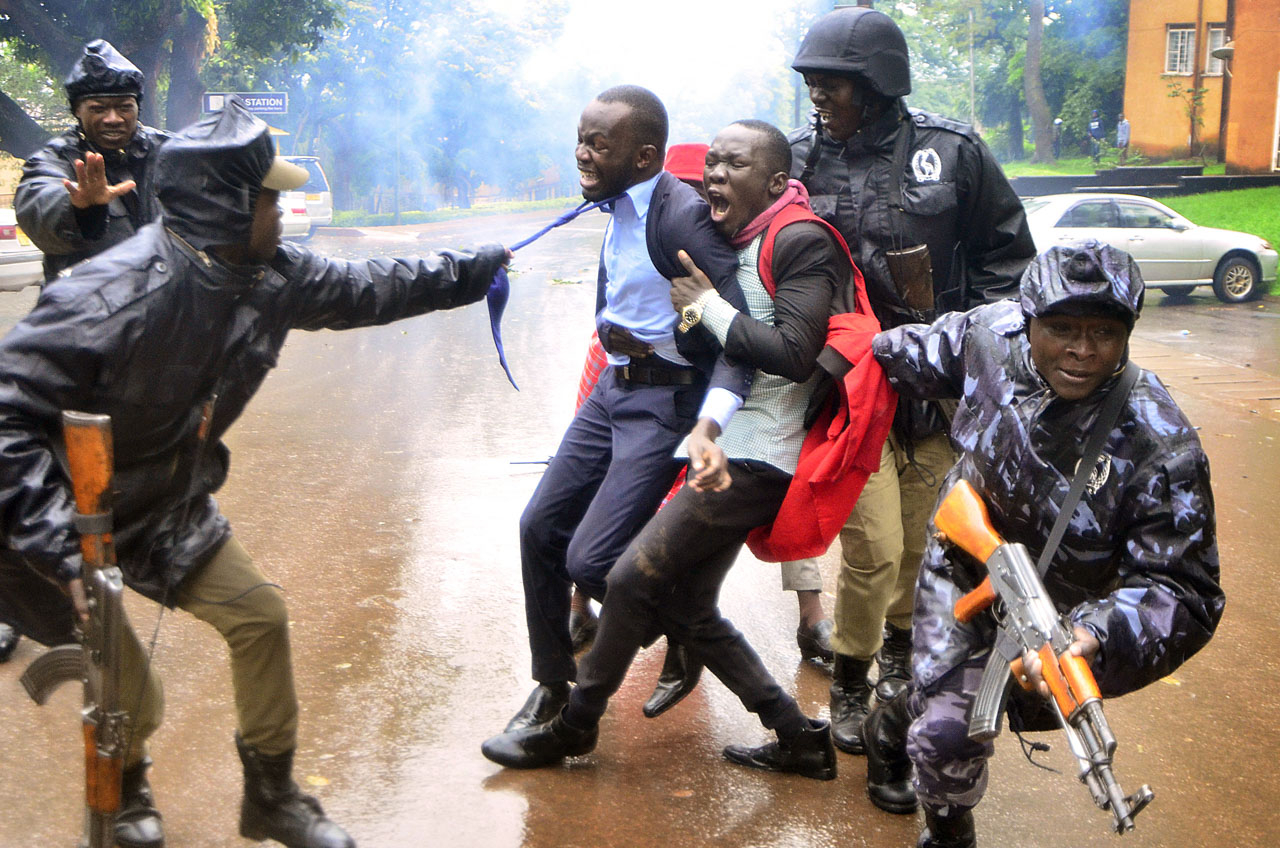 Image: Police officers arrest Makerere University Guild President Papa Were (in tie) and a colleague at Makerere University during students protests on 16th April 2018 ©Alex Esagala